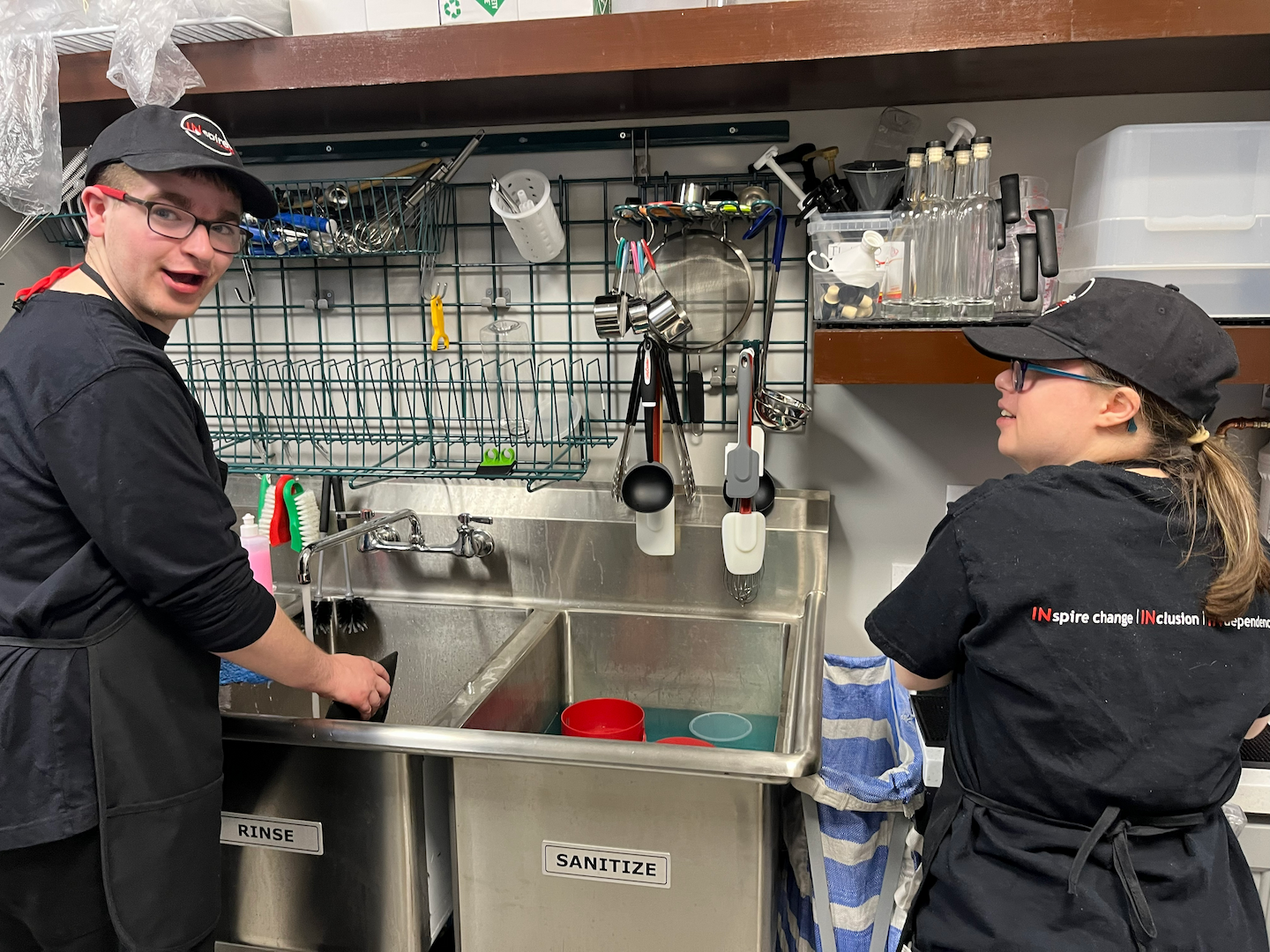 Two INspire Cafe team members working together in the kitchen